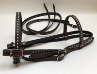 Dark brown handmade bridles and reins with buck stitch and white lace