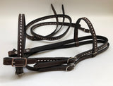 Dark brown handmade bridles and reins with buck stitch and white lace